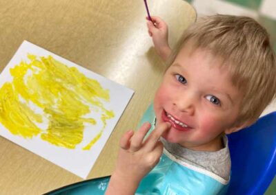 Boy smiling while painting