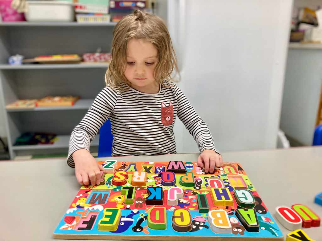 girl playing with a puzzle